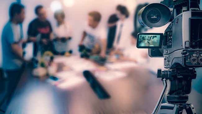 people chatting in front of a video camera