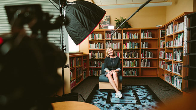 woman sitting in front of camera being filmed